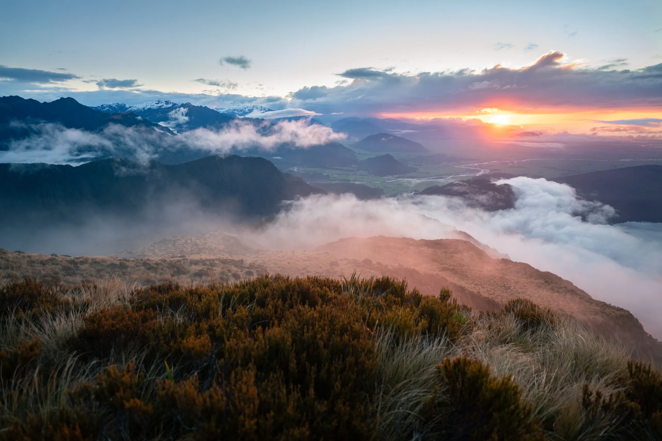 View towards the coast as the clouds clear for sunset. Kokatahi River is prominent.